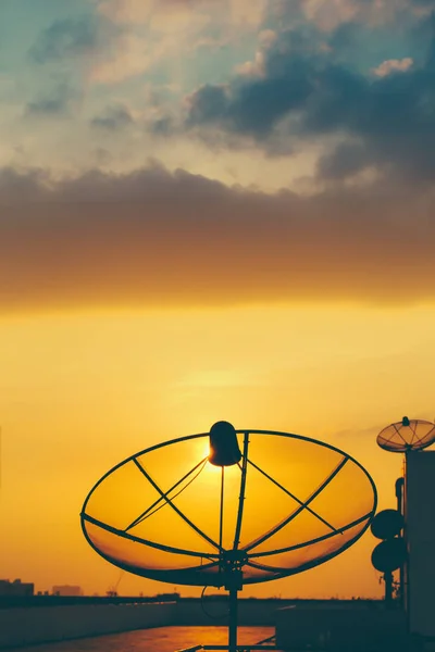 Satellite dish in golden sunset sky background. — Stock Photo, Image