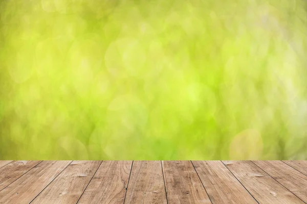 Wood floor with blur green nature bokeh vintage color tone background. — Stock Photo, Image