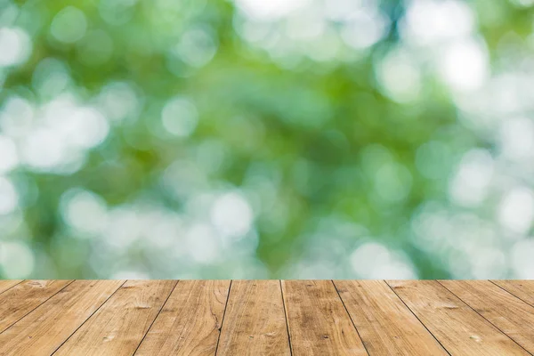Unschärfe Garten Bokeh grünen Naturpark mit Holzboden für Hintergrund. — Stockfoto