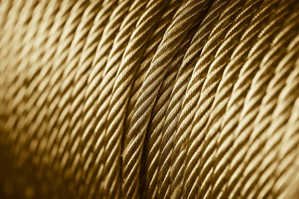Gold color clean new steel cable steel wire or steel rope, rope sling drum. — Stock Photo, Image