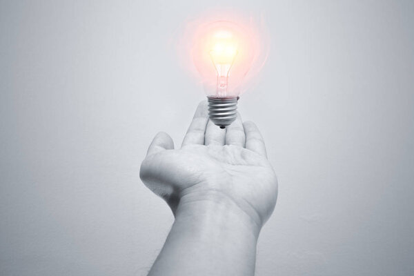 new idea in your hand. light bulb flood in the air over male hand