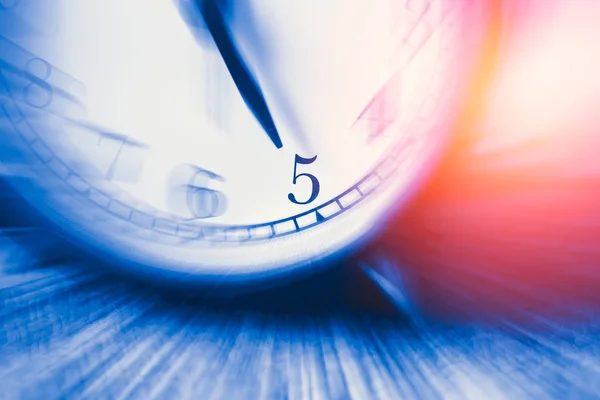 clock time with zoom motion blur focus at 5 o\'clock