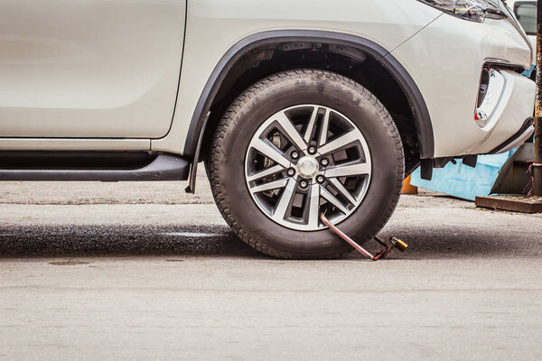 Clamped Wheel, Car Locked by Police for Prohibit Parking.