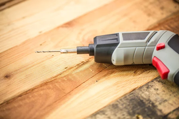 Hand Drill on Wood background, Home DIY Wokshop Concept. — Stock Photo, Image