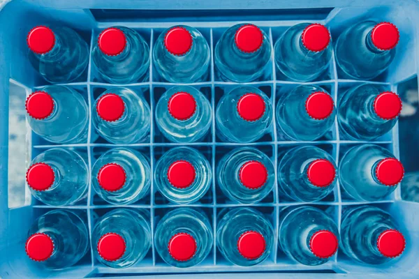 Glass drink bottle box for transport. drinking water background, clean water. — Stock Photo, Image