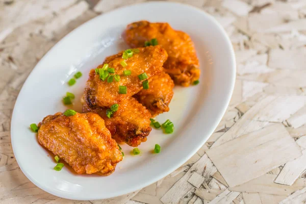 Menù delle ali di pollo fritte piccanti sul piatto servito con tavolo di legno . — Foto Stock