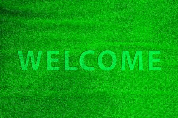 Palavra de boas-vindas tapete de algodão colorido em verde . — Fotografia de Stock