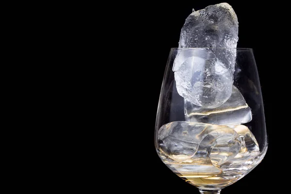 Ice in win glass isolated on black background. — Stock Photo, Image