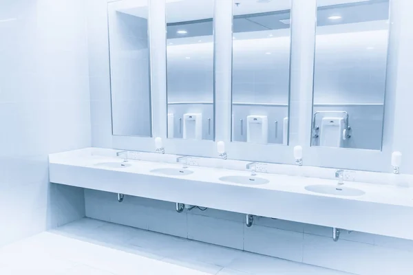Czyste nowe nowoczesne wnętrza Toaleta Umywalka wiersz niebieski odcień. natryskiem wody w łazience. — Zdjęcie stockowe