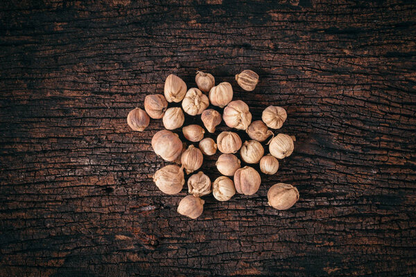 Siam Cardamom (Amomum krervanh Pierre) dried on wood background