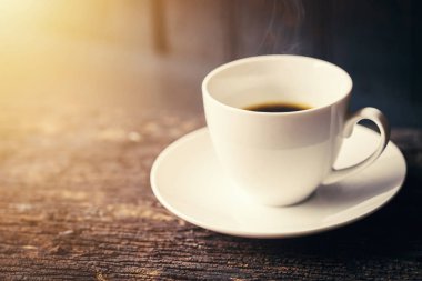 Espresso kahve ya da Amerikalı siyah kahve kopya alanı ile ahşap masa üzerinde beyaz Kupası.