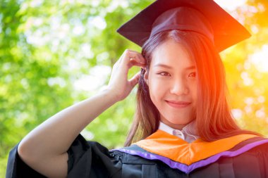 Asyalı güzel kadın portre mezuniyet yeşil doğa arka plan, Tayland Üniversitesi ile.