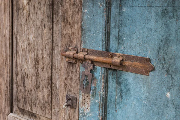 rust steel grunge slide door lock on wood door.