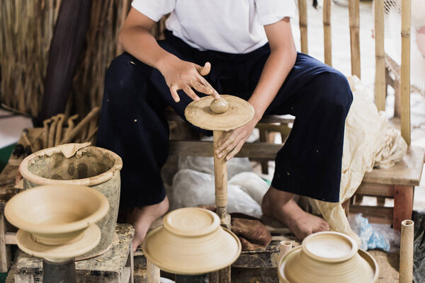 senior asian handcraft potter making clay pot 