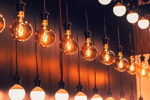 Row of Retro industrial loft style hanging tungsten lamp bulb decoration old vintage modern home.
