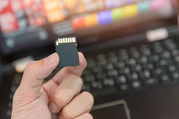 SD card with laptop computer background — Stock Photo, Image