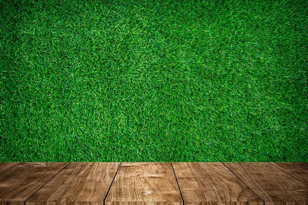 Wood foreground with green grass sport field — Stock Photo, Image