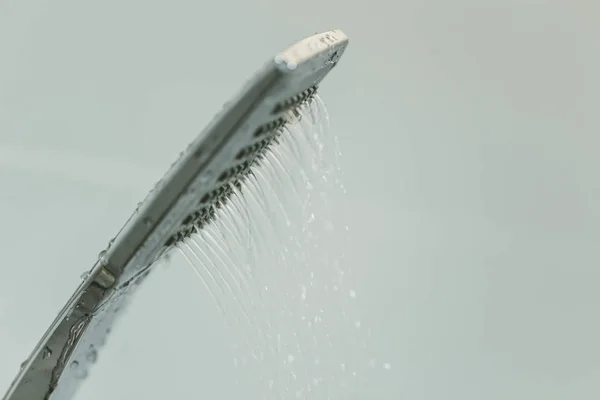 Low water pressure problem closeup at shower head in white bathroom — Stock Photo, Image