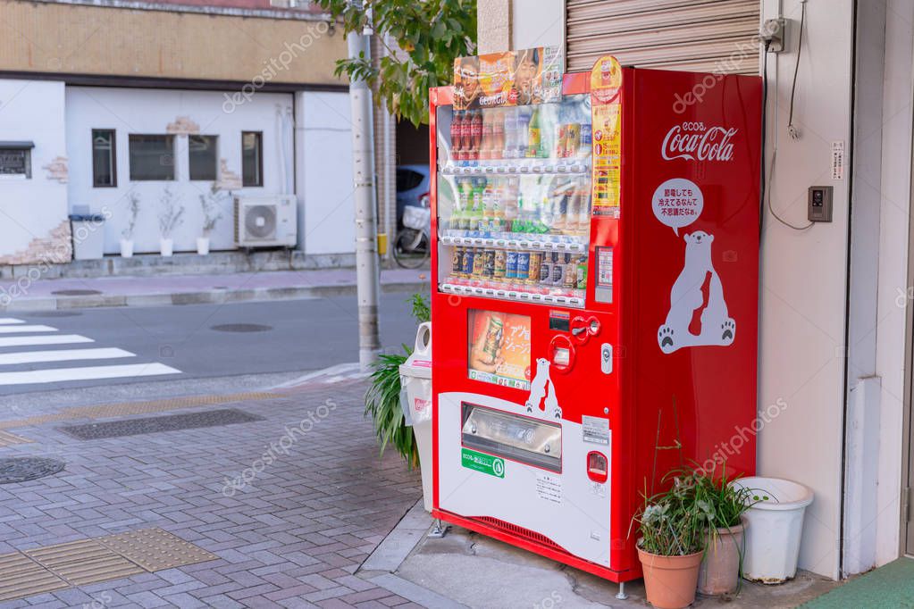 Eco Coca-Cola red vending machines sell beverage products with cute polar bear mascot found around Osaka Japan December 2017.