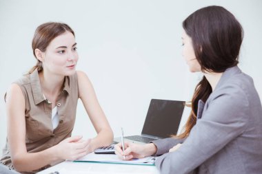 Businessewoman talking together with boss work discustion at office desk.