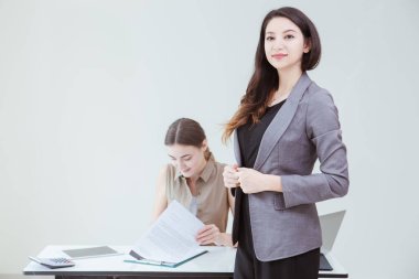 Businesswomen leader or business smart lady standing in the office with happy employee staff under worker.