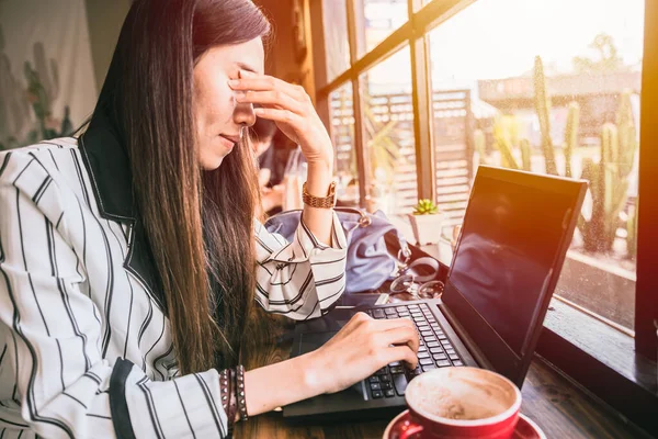 Business woman eye pain strain fatigue from computer vision syndrome.