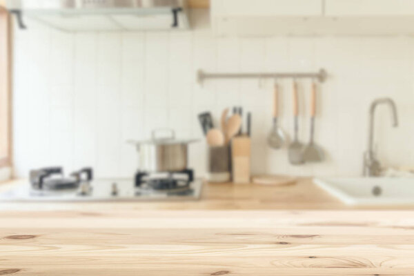 Kitchen background blur with wooden top table clean white for kitchenware montage advertising banner layout.