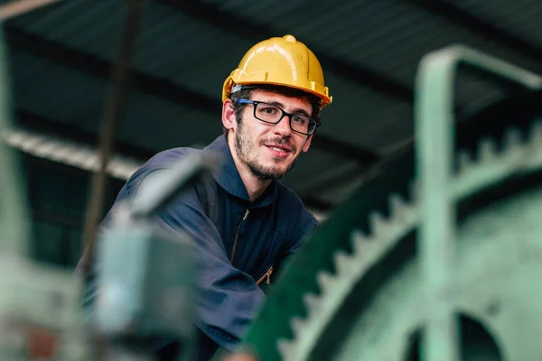 Portrait of young American happy worker enjoy happy smiling to work in a heavy industrial factory.