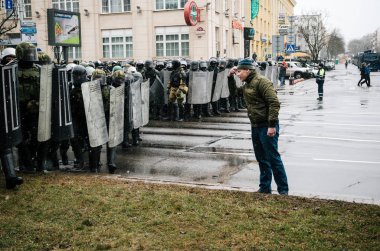 Special police unit with shields against protesters in Minsk clipart