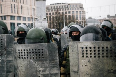 Special police unit with shields against protesters in Minsk clipart