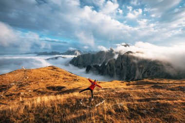 Traveler stands at Tre Cime di Lavaredo in Dolomites, Italy