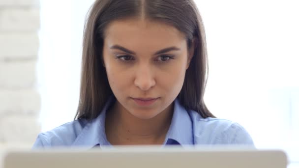 Σοβαρή νεαρή γυναίκα στο χώρο εργασίας, φορητό υπολογιστή — Αρχείο Βίντεο