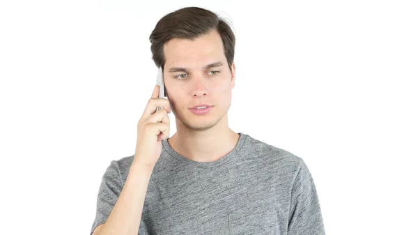 Retrato de un joven casual hablando por teléfono. fondo blanco —  Fotos de Stock