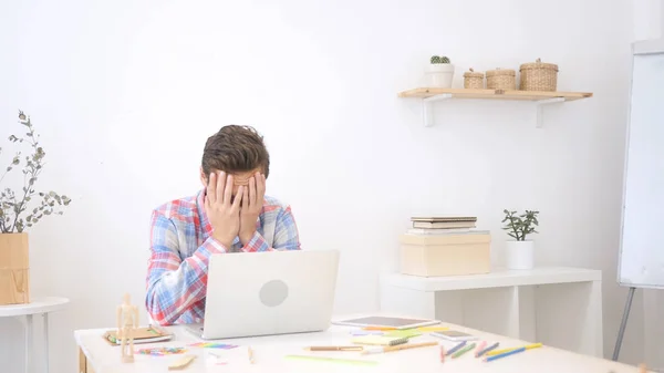 Unhappy man with computer reacting to bad news , Loss of Work