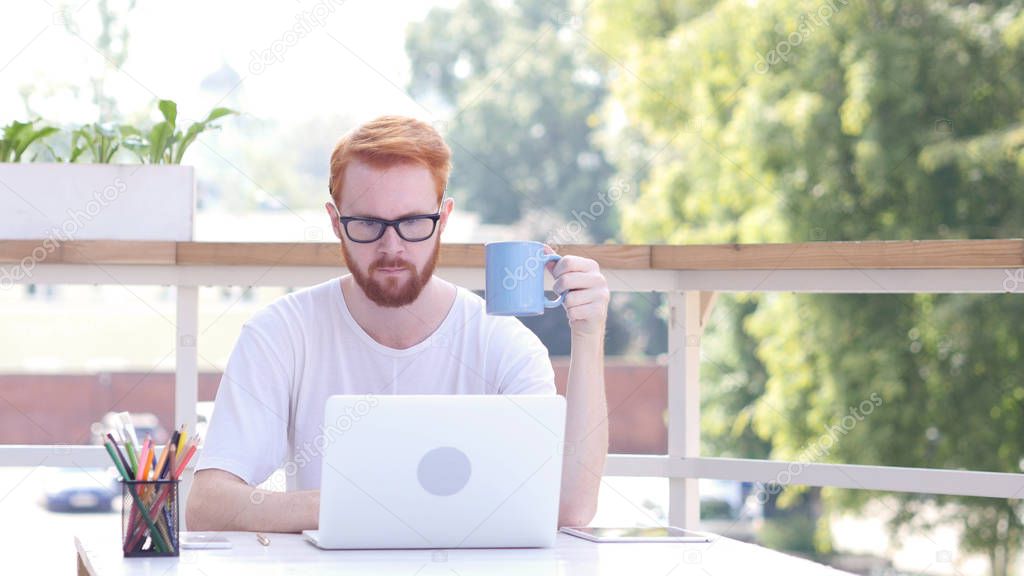 Drinking Coffee, Working Online on Laptop, Sitting in Outdoor Office, Red Hairs