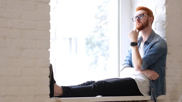 Thinking Designer, Sitting in Window, Red Hairs and Beard