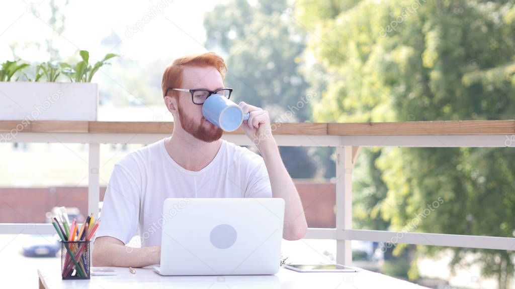 Taking Sip of Hot Coffee, Drinking while Sitting in Outdoor Office, Red Hairs