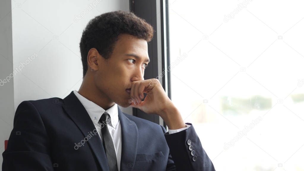 Thinking Pensive Afro-American Businessman in Suit, Looking Through Window