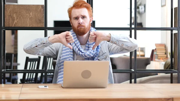 Thumbs Down by Man Working on Laptop