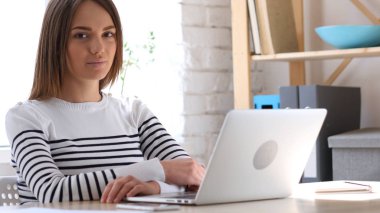 Güzel kadın iş yerinde kamera bakıyor