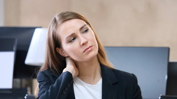 Mujer cansada en la oficina con dolor de cuello — Foto de Stock