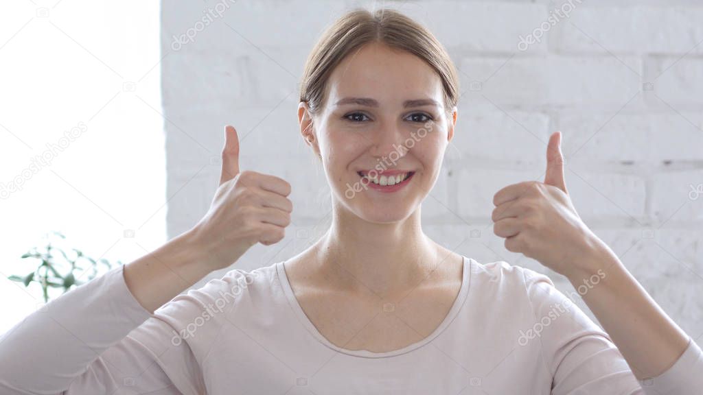 Beautiful Young Woman Gesturing Thumbs Up