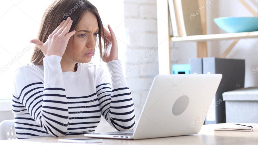 Woman Reacting to Online Loss on Laptop