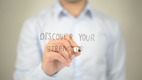 Discover Your Strengths, man writing on transparent screen
