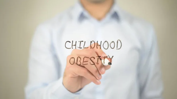 Childhood Obesity, man writing on transparent screen