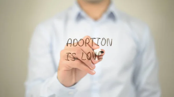 Adortion Is Love, hombre escribiendo en pantalla transparente — Foto de Stock