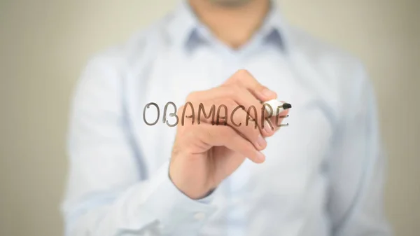 Obamacare, άνθρωπος εγγράφως σχετικά με διάφανη οθόνη — Φωτογραφία Αρχείου
