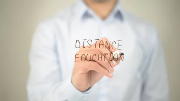 Distance Education, man writing on transparent screen — стоковое фото