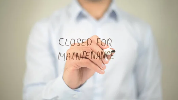 Closed for Maintenance, man writing on transparent screen
