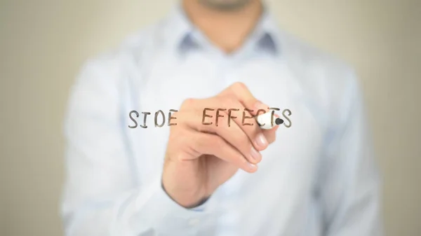 Side Effects,  Man writing on transparent screen — Stock Photo, Image